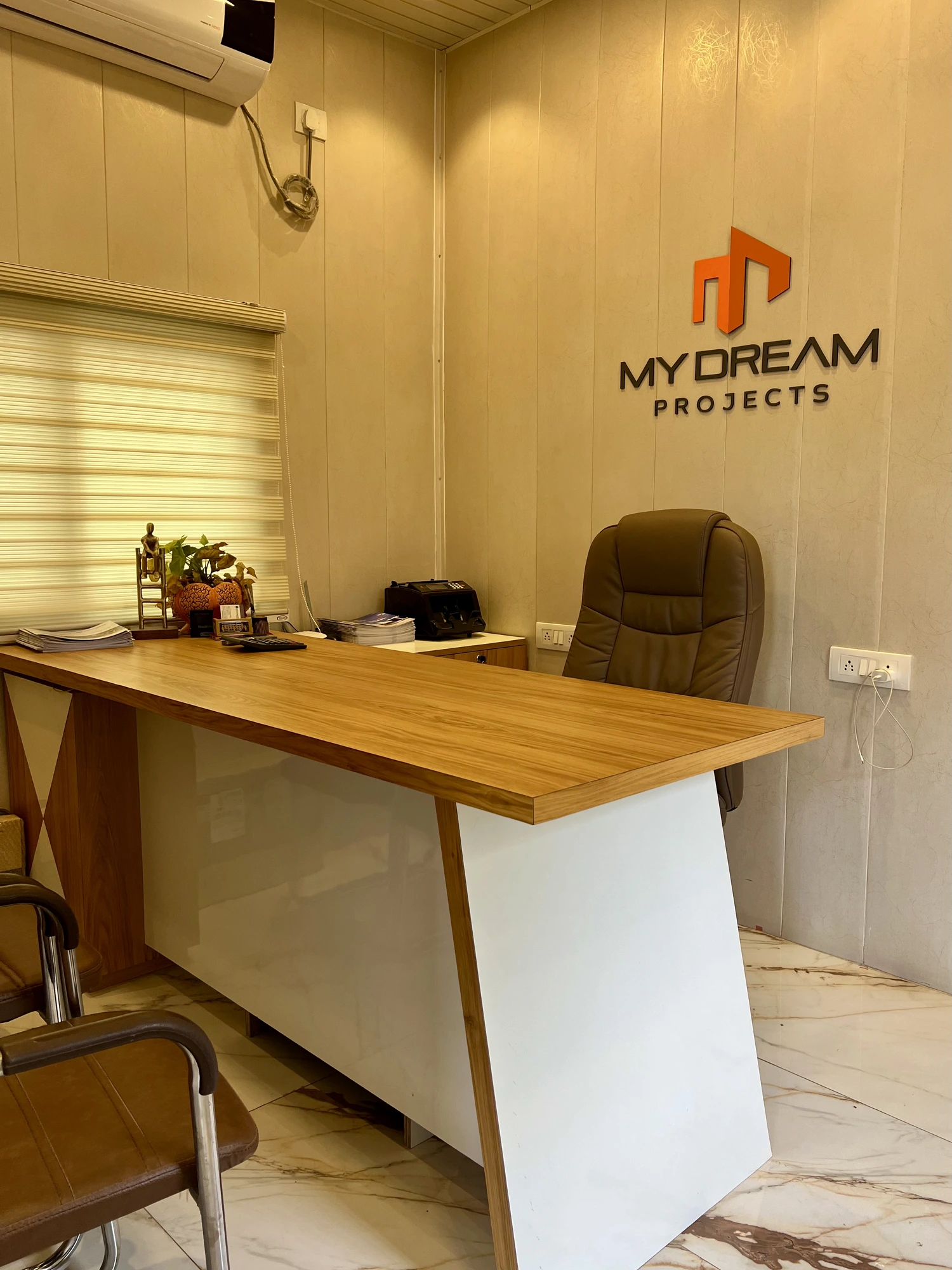 My Dream Projects office interior with desk, chairs and My Dream Projects logo on the wall